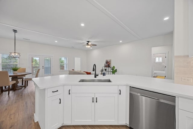 17701 Village Dr, Dripping Springs, TX 78620 - kitchen with dishwasher, a sink, a ceiling fan, light countertops, and recessed lighting