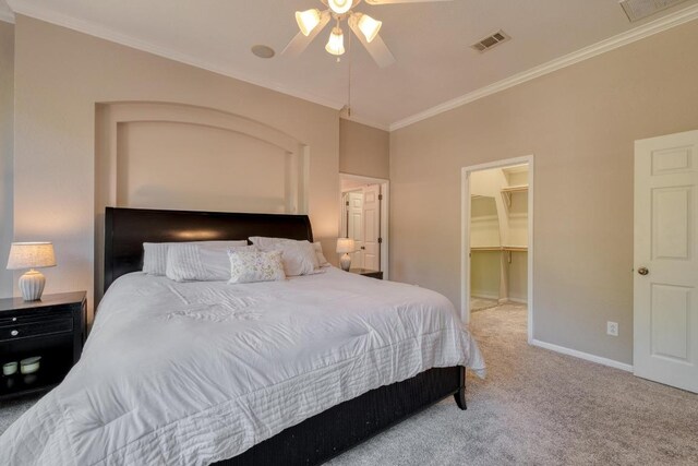 bedroom with carpet floors, visible vents, crown molding, and baseboards