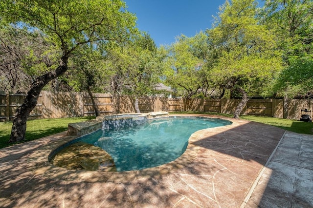 view of swimming pool with a pool with connected hot tub, a lawn, a patio, and a fenced backyard