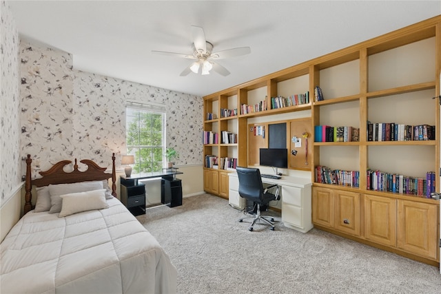 bedroom with wallpapered walls, ceiling fan, and light carpet