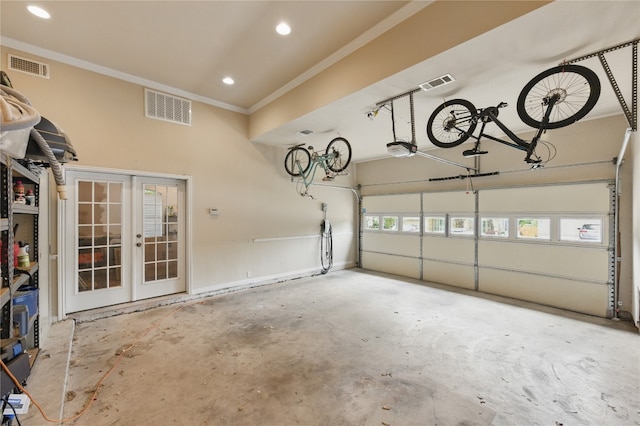 garage with visible vents, recessed lighting, and a garage door opener