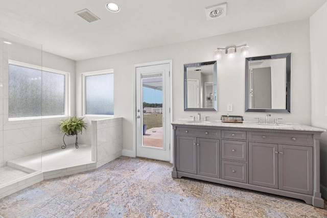 bathroom with recessed lighting, a sink, visible vents, and double vanity