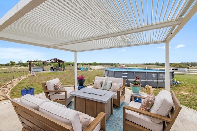 view of patio featuring fence, an outdoor pool, outdoor lounge area, and a gazebo