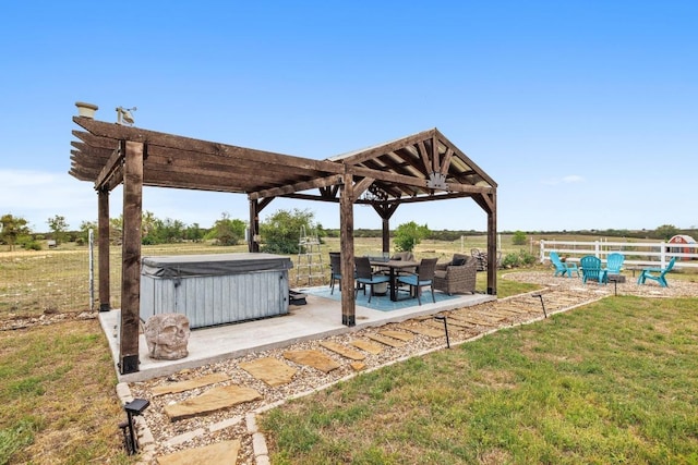 view of patio featuring fence and a hot tub