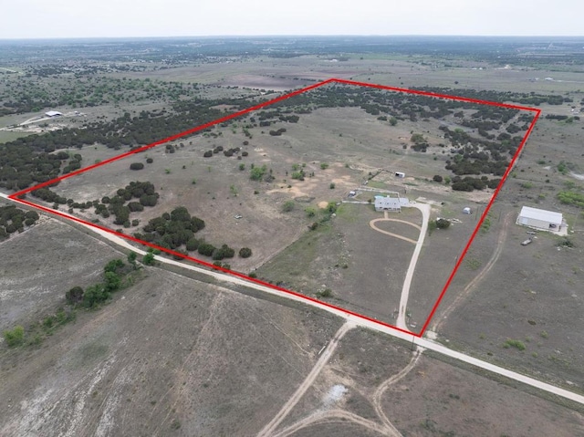 birds eye view of property featuring a rural view