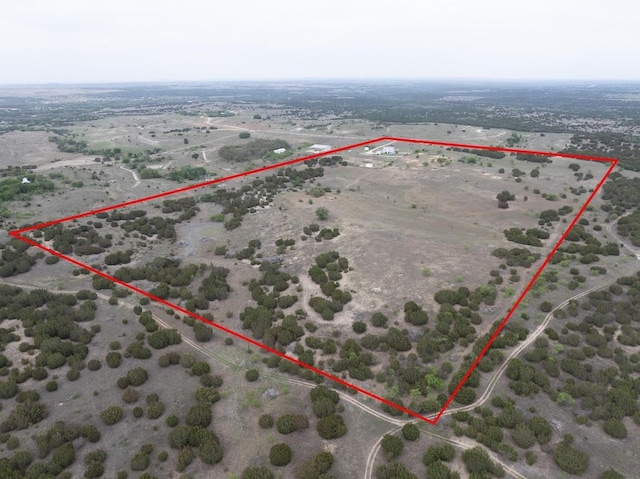 drone / aerial view featuring a desert view and a rural view