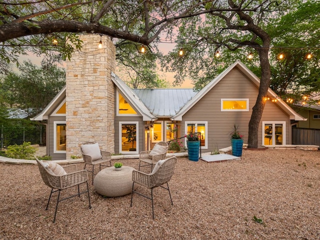 2608 S 2nd St, Austin, TX 78704 - back of property at dusk with metal roof and a chimney