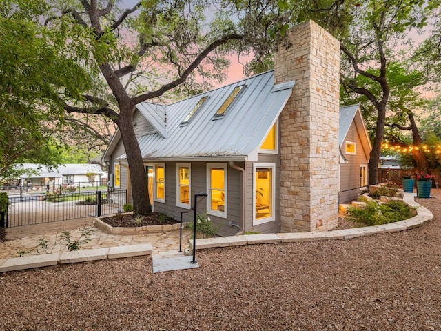 2608 S 2nd St, Austin, TX 78704 - view of front of house featuring a standing seam roof, metal roof, and a chimney