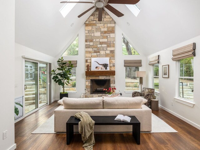 2608 S 2nd St, Austin, TX 78704 - living room with a skylight, high vaulted ceiling, a ceiling fan, a fireplace, and plenty of natural light