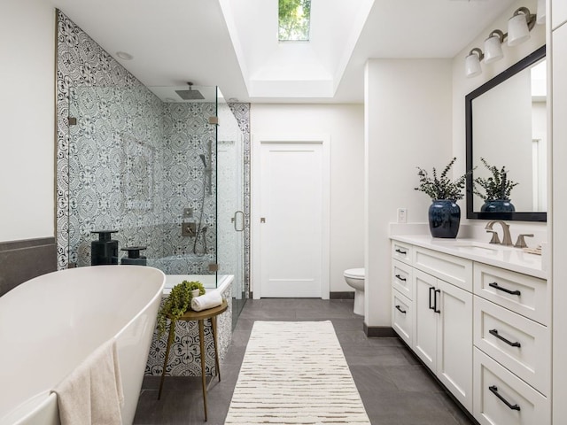 2608 S 2nd St, Austin, TX 78704 - full bath featuring vanity, a stall shower, a soaking tub, toilet, and a skylight
