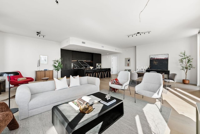 44 E Ave Unit 2301, Austin, TX 78701 - living area with light wood-style flooring and rail lighting
