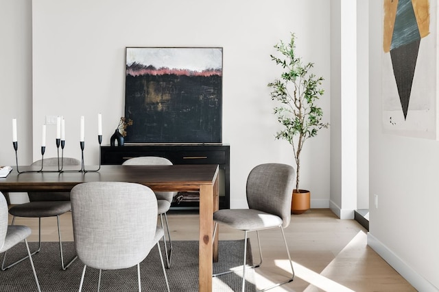 44 E Ave Unit 2301, Austin, TX 78701 - dining space featuring baseboards and wood finished floors