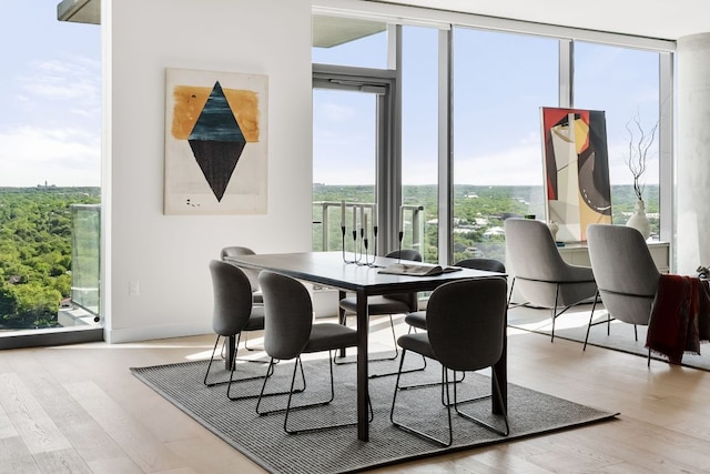 44 E Ave Unit 2301, Austin, TX 78701 - dining area with a wall of windows and wood finished floors