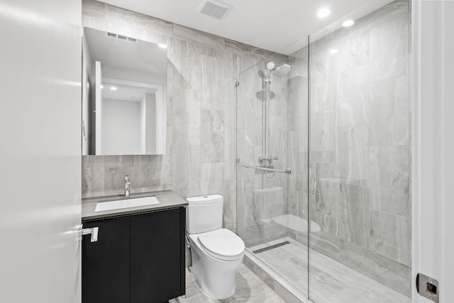 44 E Ave Unit 2301, Austin, TX 78701 - full bath with tile walls, a shower stall, vanity, and recessed lighting