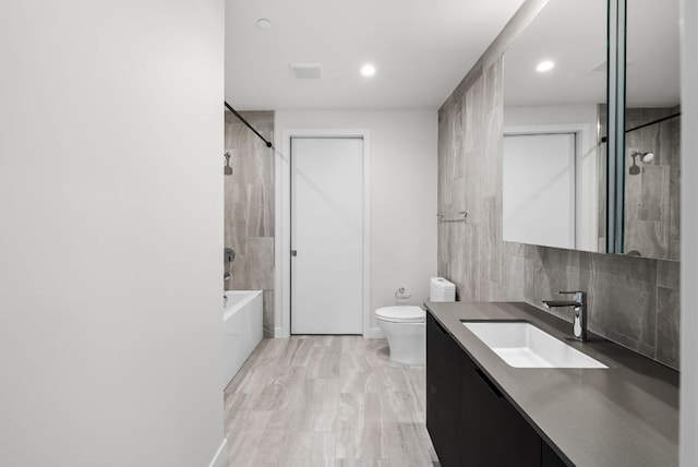 44 E Ave Unit 2301, Austin, TX 78701 - bathroom featuring  shower combination, tasteful backsplash, toilet, recessed lighting, and vanity