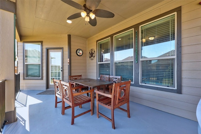 view of patio with outdoor dining space and a ceiling fan