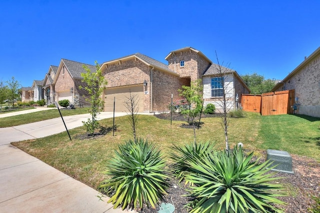 141 Green Knoll Ln, Georgetown, TX 78628 - view of front of property featuring a garage, driveway, and brick siding