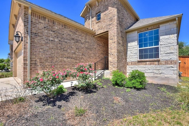 141 Green Knoll Ln, Georgetown, TX 78628 - view of side of property with brick siding, stone siding, and concrete driveway