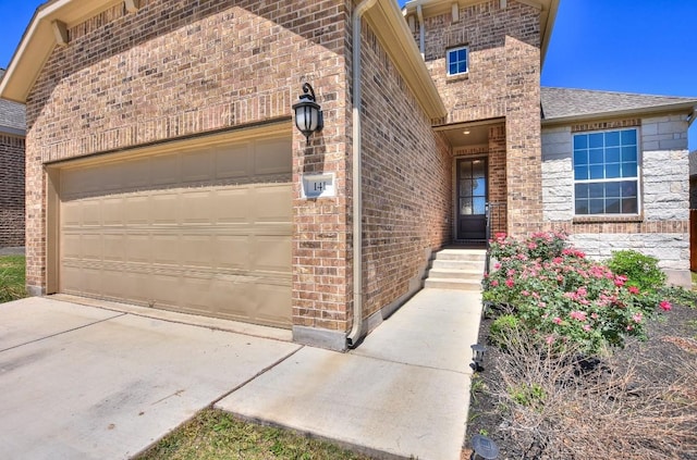 141 Green Knoll Ln, Georgetown, TX 78628 - entrance to property featuring brick siding, a garage, a shingled roof, and concrete driveway