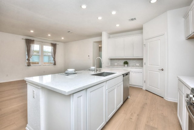 141 Green Knoll Ln, Georgetown, TX 78628 - kitchen featuring a sink, appliances with stainless steel finishes, light wood finished floors, light countertops, and recessed lighting