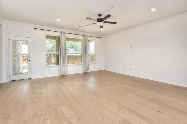 141 Green Knoll Ln, Georgetown, TX 78628 - unfurnished room featuring plenty of natural light, baseboards, light wood-style floors, and recessed lighting