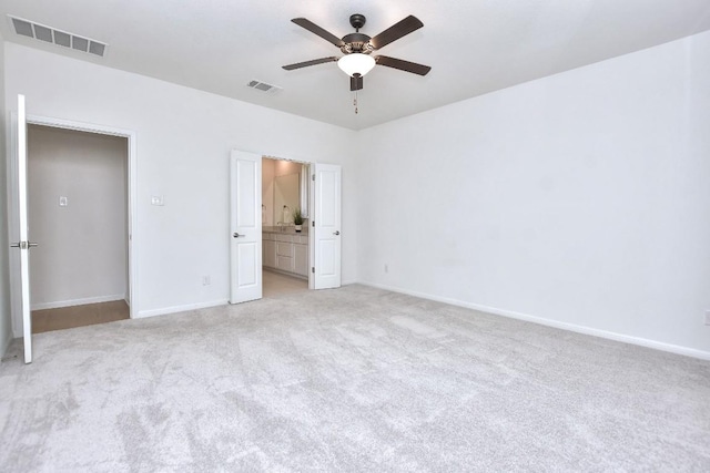 141 Green Knoll Ln, Georgetown, TX 78628 - unfurnished bedroom with light carpet, baseboards, ceiling fan, and ensuite bathroom