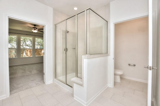 141 Green Knoll Ln, Georgetown, TX 78628 - bathroom featuring a ceiling fan, a shower stall, toilet, and tile patterned flooring