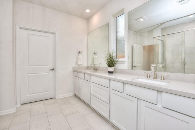 141 Green Knoll Ln, Georgetown, TX 78628 - bathroom with double vanity, a shower stall, and baseboards