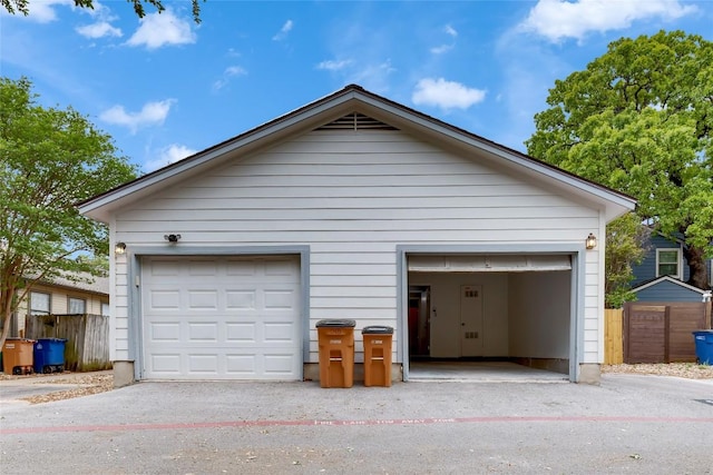 detached garage featuring fence