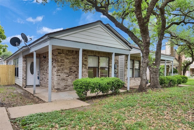 view of front of house with brick siding and fence