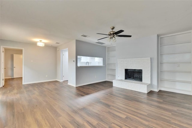unfurnished living room with ceiling fan, baseboards, built in features, and visible vents