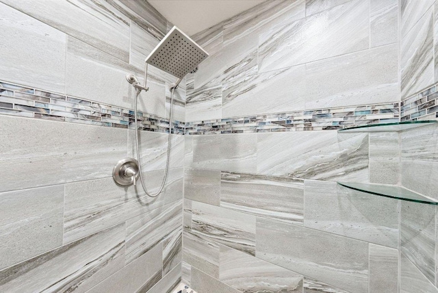 interior details featuring tiled shower