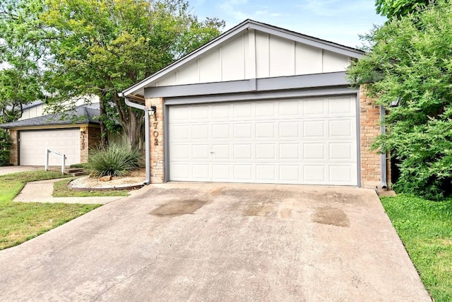 ranch-style home with an outdoor structure, a garage, board and batten siding, and brick siding