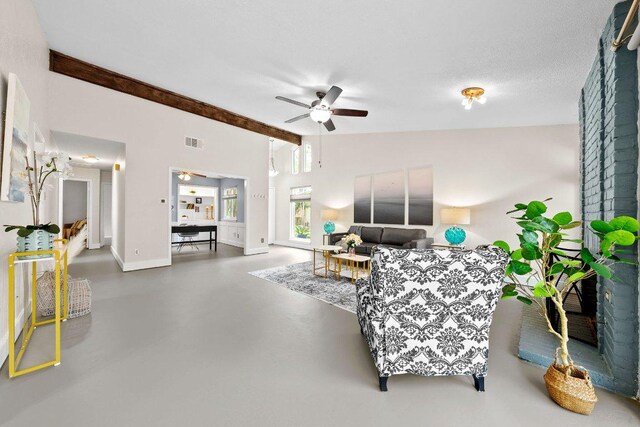 living room featuring visible vents, baseboards, concrete flooring, a ceiling fan, and vaulted ceiling with beams