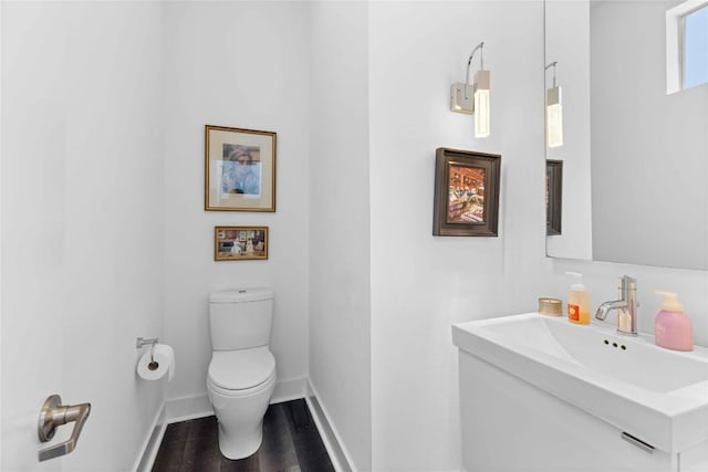 2105 Goodrich Ave Unit 7, Austin, TX 78704 - bathroom featuring toilet, vanity, wood finished floors, and baseboards