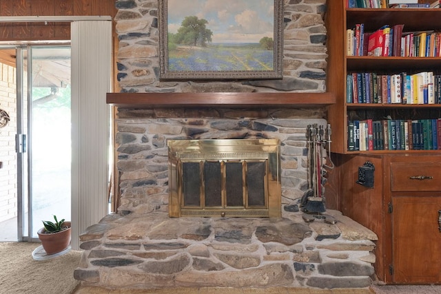room details featuring carpet and a fireplace