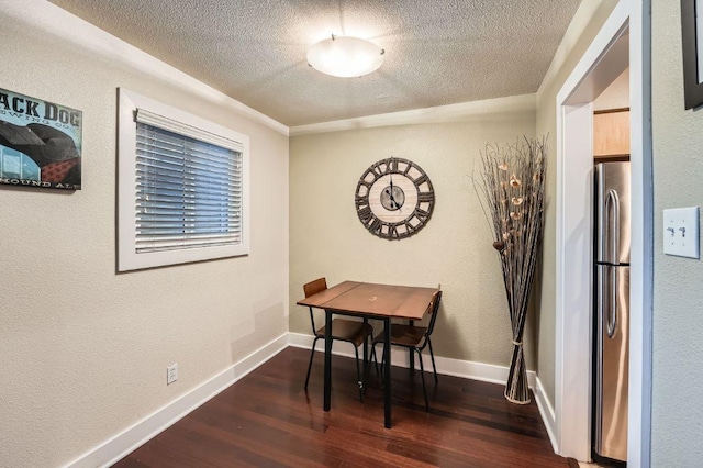 3815 Guadalupe St Unit 103, Austin, TX 78751 - dining area featuring a textured ceiling, dark wood-type flooring, and a textured wall