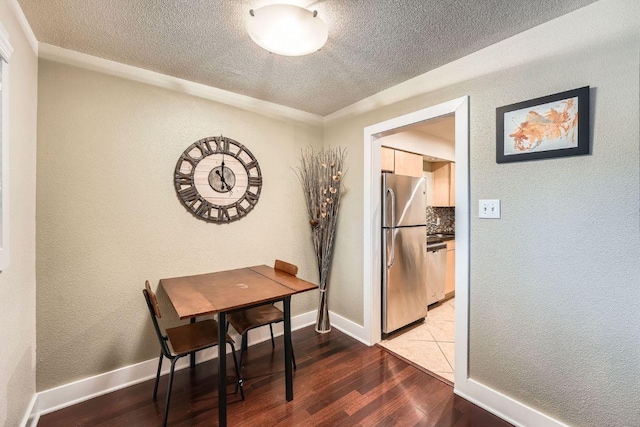 3815 Guadalupe St Unit 103, Austin, TX 78751 - dining space with a textured ceiling, wood finished floors, and a textured wall