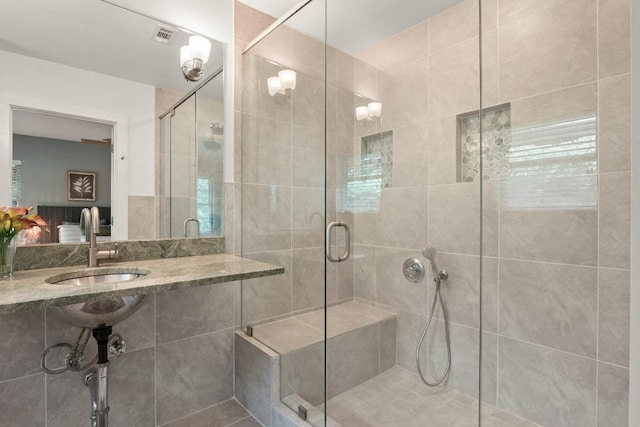 2213 Rebel Rd, Austin, TX 78704 - bathroom featuring visible vents, a stall shower, and a sink