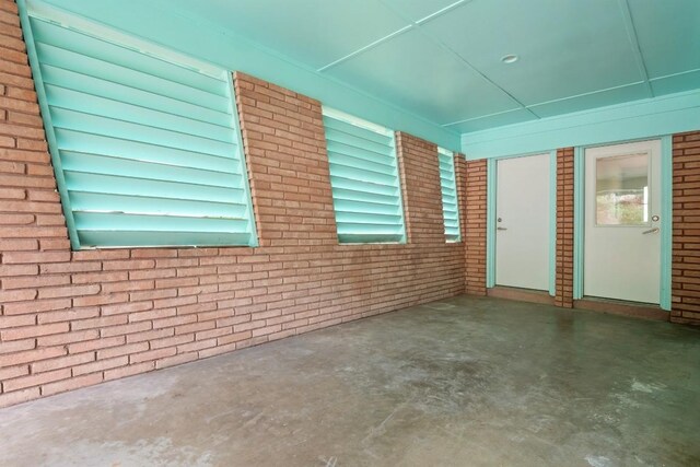 2213 Rebel Rd, Austin, TX 78704 - exterior space featuring unfinished concrete flooring and brick wall