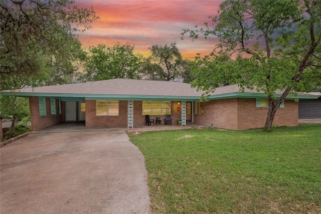 2213 Rebel Rd, Austin, TX 78704 - ranch-style home featuring brick siding, driveway, and a yard