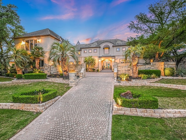 8300 Chalk Knoll Dr, Austin, TX 78735 - view of front of house featuring stucco siding, a balcony, a front lawn, and french doors