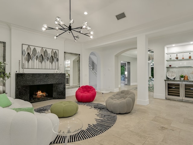 8300 Chalk Knoll Dr, Austin, TX 78735 - living room with arched walkways, ornamental molding, a bar, a chandelier, and a tile fireplace