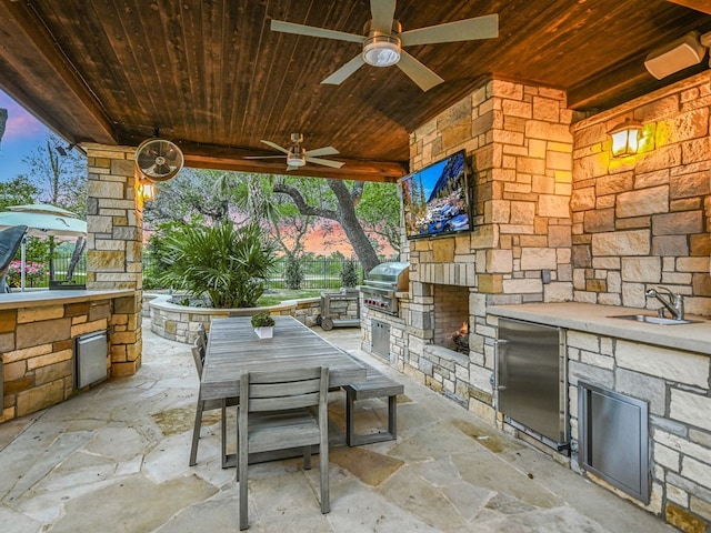 8300 Chalk Knoll Dr, Austin, TX 78735 - patio terrace at dusk with an outdoor kitchen, ceiling fan, a patio area, and outdoor dining area