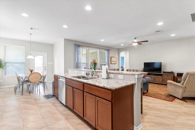 30305 Tiger Woods Dr, Georgetown, TX 78628 - kitchen featuring a sink, stainless steel dishwasher, arched walkways, open floor plan, and ceiling fan