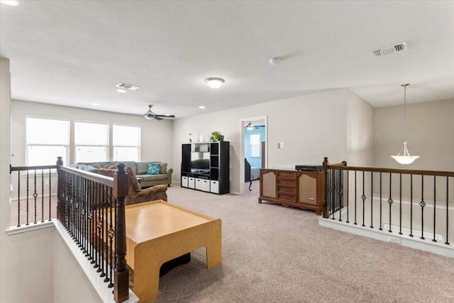 30305 Tiger Woods Dr, Georgetown, TX 78628 - carpeted living room featuring a ceiling fan and healthy amount of natural light