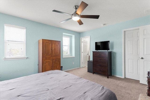30305 Tiger Woods Dr, Georgetown, TX 78628 - bedroom with light colored carpet, baseboards, and ceiling fan