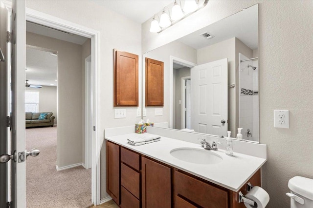 30305 Tiger Woods Dr, Georgetown, TX 78628 - bathroom with vanity, a shower, toilet, and ceiling fan