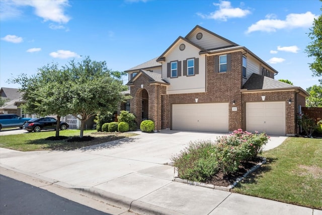 30305 Tiger Woods Dr, Georgetown, TX 78628 - traditional home featuring brick siding, driveway, an attached garage, a front yard, and a shingled roof