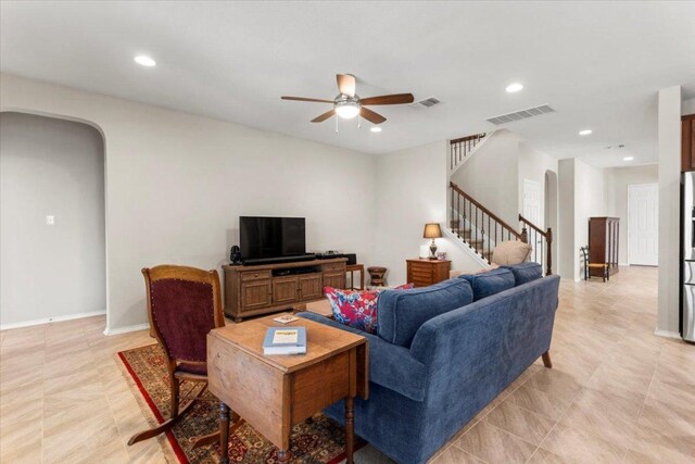 30305 Tiger Woods Dr, Georgetown, TX 78628 - living area featuring stairway, ceiling fan, arched walkways, recessed lighting, and baseboards